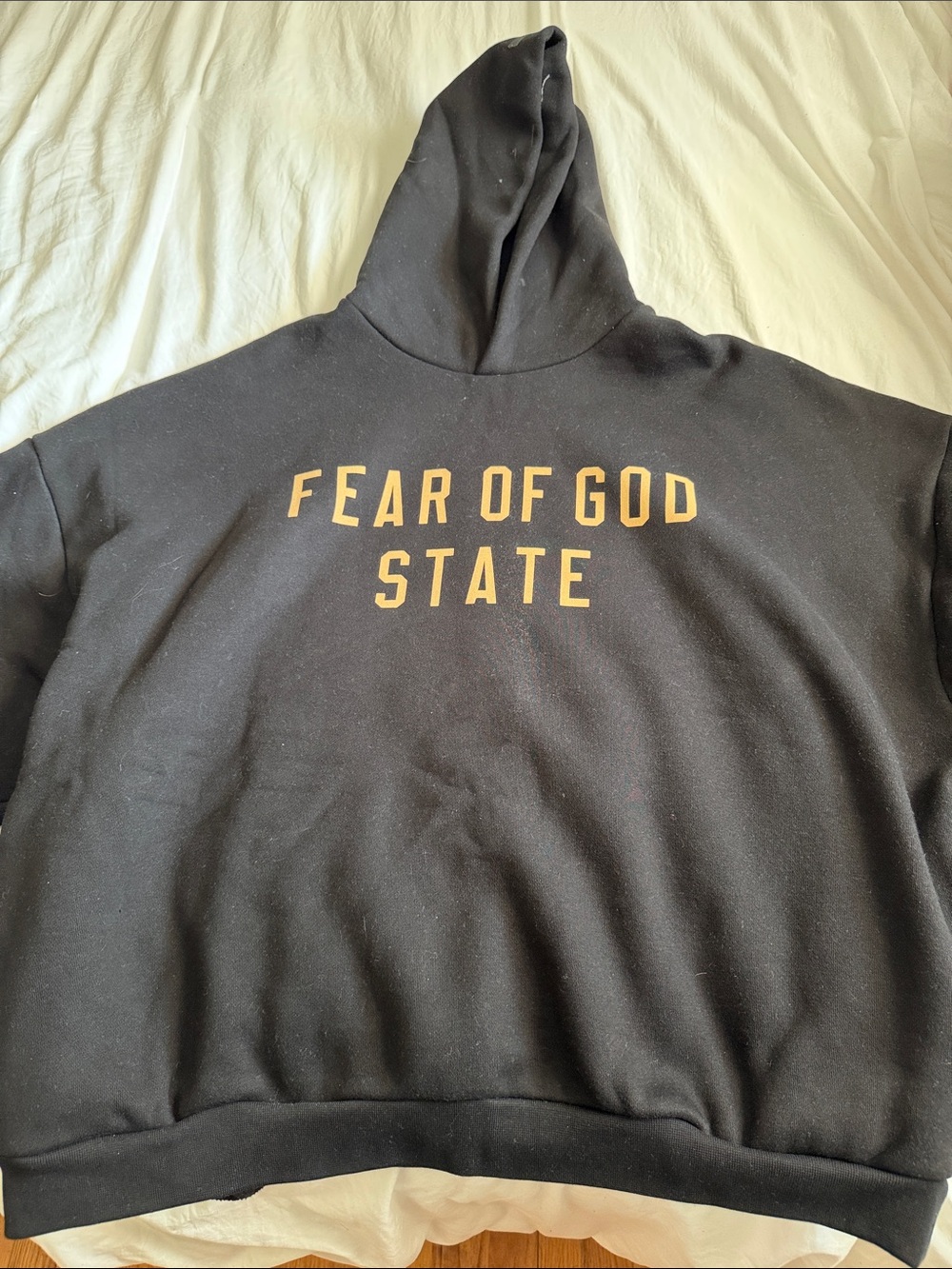 Fear of God Black Hoodie with Gold Lettering
